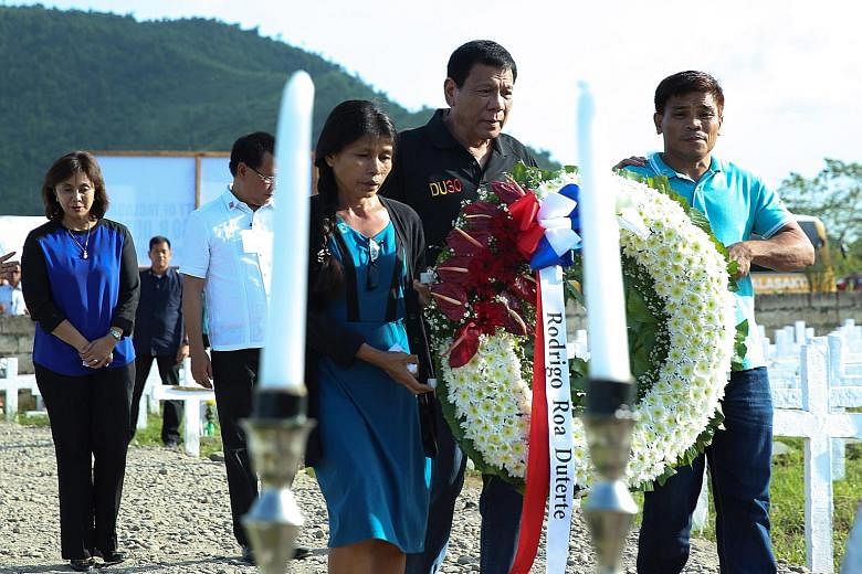 Mr Duterte (in black top) and Mrs Robredo (far left) in Tacloban City to mark the third anniversary of the Haiyan disaster. The President said he mentioned ogling the Vice-President's legs "to make people laugh because I was angry". The super typhoon
