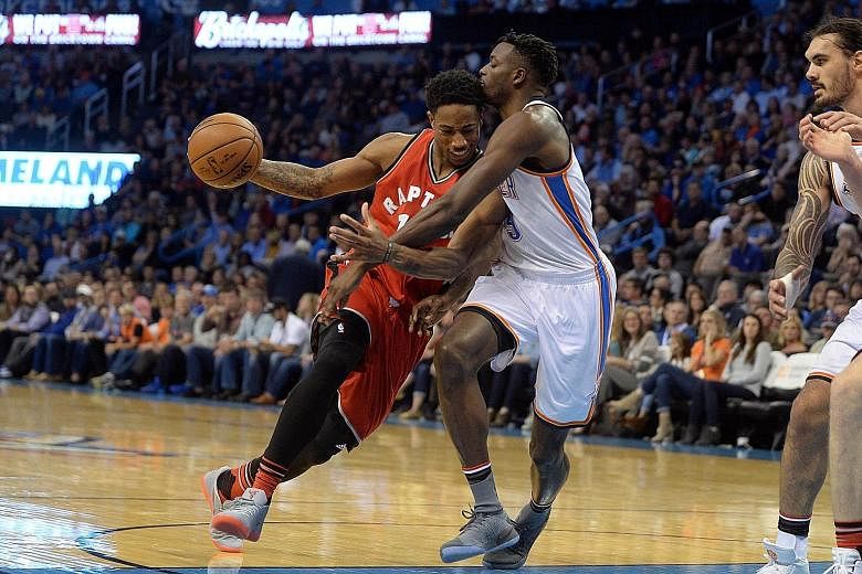 Toronto Raptors' DeMar DeRozan drives to the basket as Oklahoma City Thunder forward Jerami Grant attempts to stop the guard. After Wednesday's game-high 37-point performance, DeRozan leads the NBA in points per game (34.1). The Thunder's Russell Wes