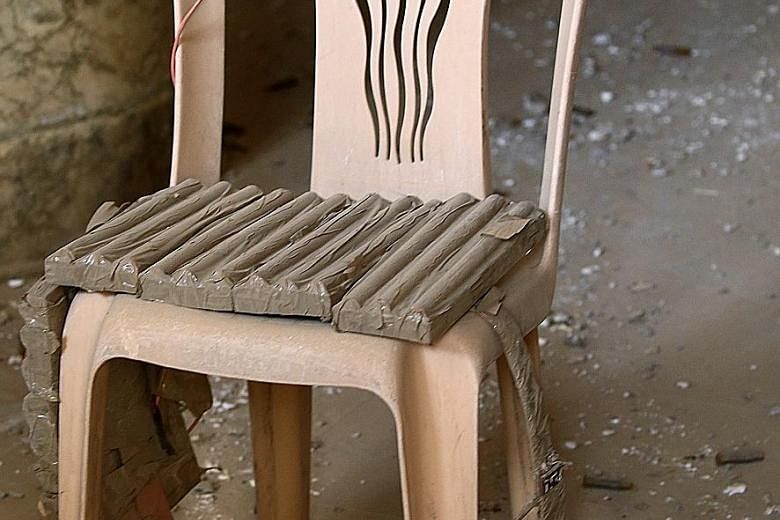An explosive belt belonging to ISIS militants is seen on a chair in Bashiqa. The Iraqi town was recaptured from ISIS as troops and allied militias advanced yesterday on villages held by the militants.