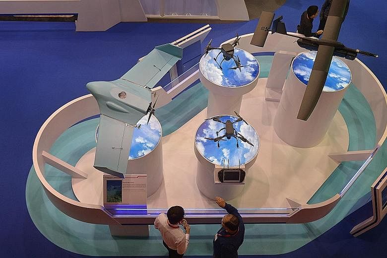 ST Engineering's drones and unmanned vehicles at the Singapore Airshow in February. The firm said it had a healthy order book of $11.4 billion as of Sept 30, although its operating environments remain challenged by uncertainties in the global economy