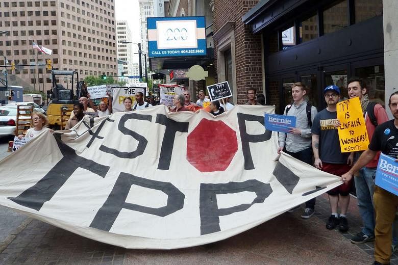 Protesters in the US calling for the rejection of the Trans-Pacific Partnership trade deal in October last year. Asian countries joined the TPP last year to balance against Beijing, but the election of Mr Trump makes Beijing look more like the stable econ