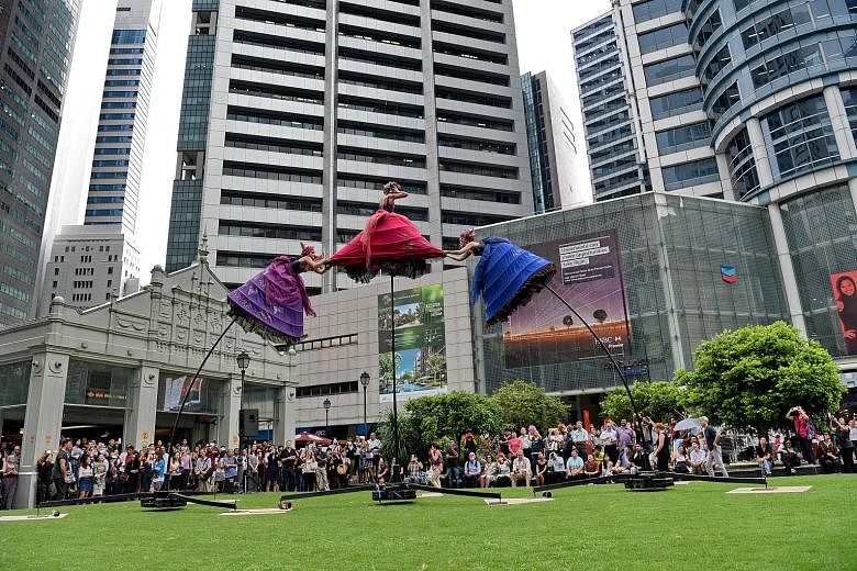Swaying back and forth atop 5m-high poles, these performers from Australian company Strange Fruit Productions caught the attention of the lunchtime crowd at Raffles Place yesterday. The show, titled The Three Belles, was part of Arts In Your Neighbou