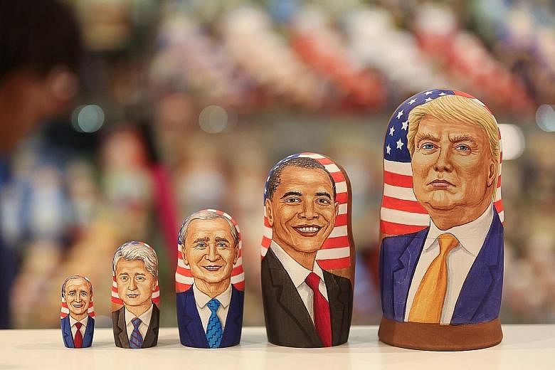 Russian nesting dolls depicting (from left) former US presidents George H.W. Bush, Bill Clinton and George W. Bush, President Barack Obama and President-elect Donald Trump at a souvenir store in Moscow on Wednesday. Mr Trump will be the first billion