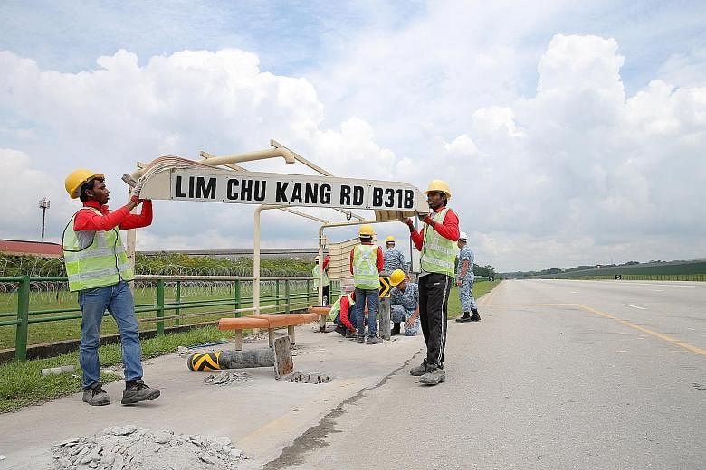 Lamp posts and other fixtures along Lim Chu Kang Road, such as this bus stop, have been temporarily removed to turn the 2.5km stretch into a runway for the Republic of Singapore Air Force's Exercise Torrent this weekend. Taking their place is equipme