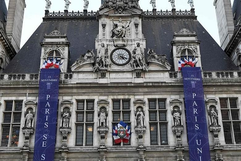 Banners reading "Paris remembers" and "Paris united" are hung on the facade of the City Hall in Paris. Tomorrow, France will mark the first anniversary of coordinated terror attacks in and around Paris that left 130 people dead.