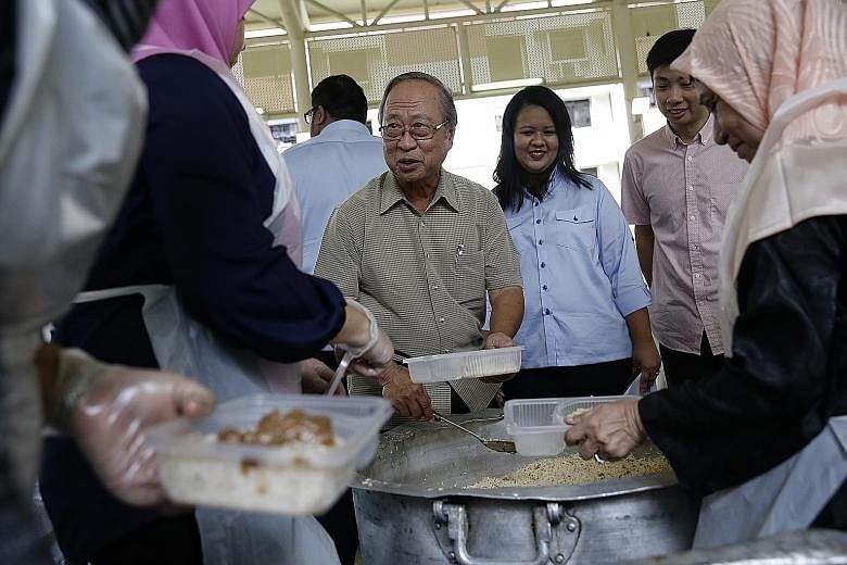Dr Tan attending a charity event by Free Food For All in Chai Chee yesterday. He said he will not retreat from the public eye and will still help Singapore.