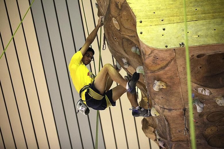 Ruzaini Hilmi Ahmad, a member of Outram Secondary School’s rock-climbing team. The school has a 10m-high rock-climbing wall in its hall.