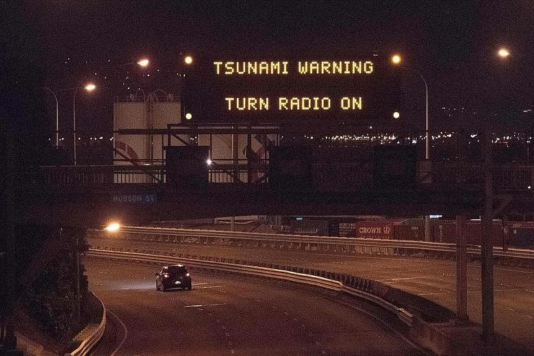 A noticeboard above State Highway 1 in Wellington displaying a tsunami warning alert. The powerful earthquake was centred some 90km north of the South Island city of Christchurch and felt throughout the country. Although no injuries were reported, th