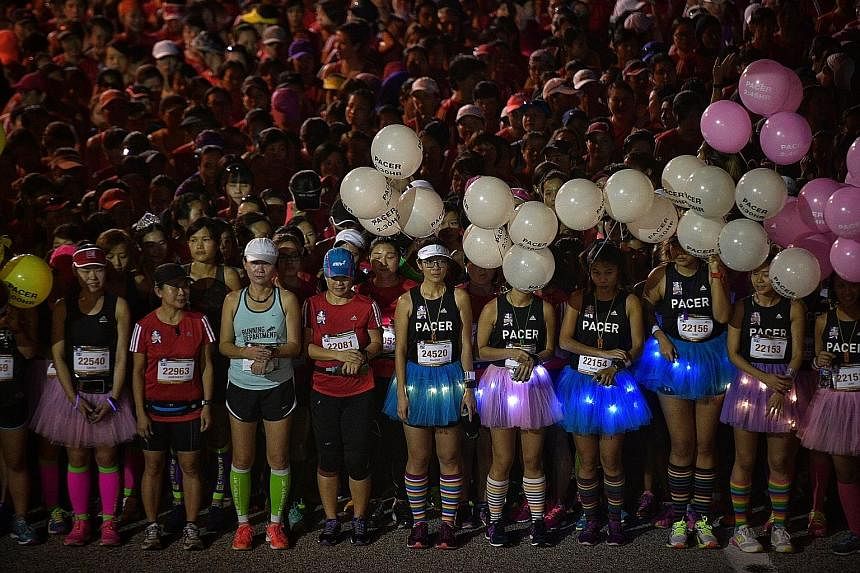 From top: Participants commencing the 21.1km half-marathon at the Great Eastern Women's Run 2016 yesterday. Pacers with balloons, tutus and multi-coloured socks waiting at the start point before the race. Jo Un Ok of North Korea crossing the finish l