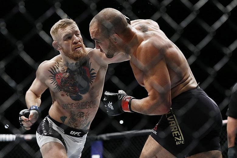 Conor McGregor (left) fighting Eddie Alvarez in their lightweight title bout during UFC 205 at Madison Square Garden on Saturday. McGregor won to improve to 21-3 in MMA competition and 9-1 in UFC.