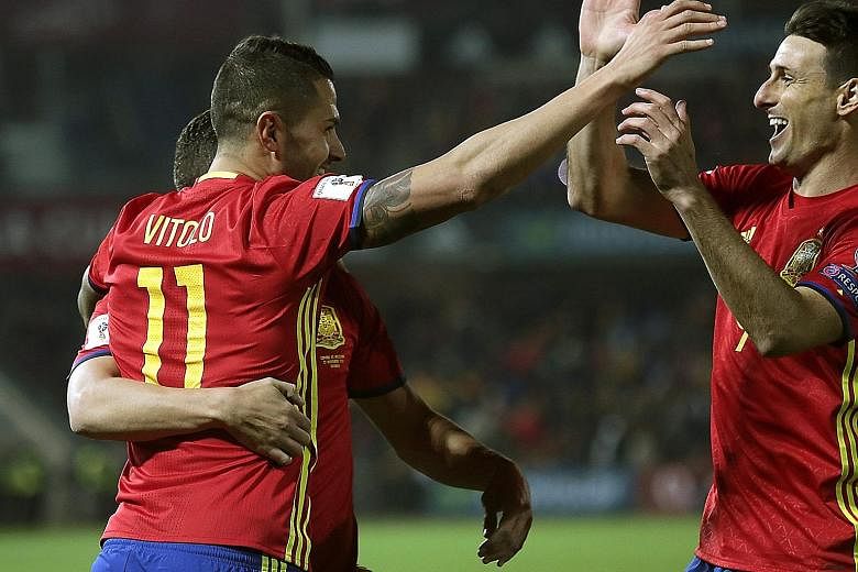 Spaniard Vitolo celebrating his goal with team-mate Aritz Aduriz (right) during the World Cup qualifier against Macedonia. Spain won 4-0 to top Group G on goal difference, ahead of Italy.
