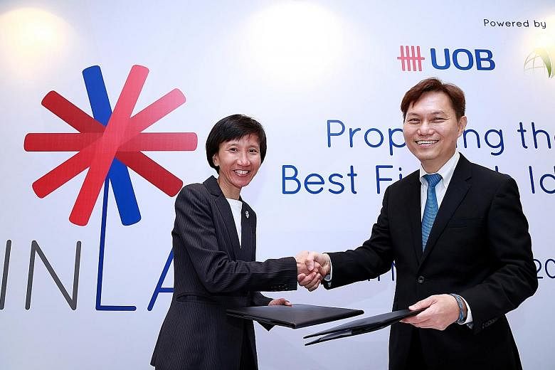 Ms Janet Young, head of Group Channels and Digitalisation at UOB, with Dr Alex Lin, head of Infocomm Investments, after signing The FinLab joint-venture agreement.