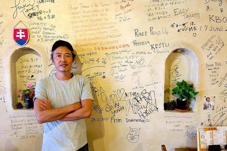 Above: Mr Goka,the owner of Nikkoken restaurant in Sano city, in front of a wall on which customers have left their mark. Every year, the restaurant serves around 1,000 Muslim tourists from places such as Indonesia and Saudi Arabia. Left: Sekai Cafe 