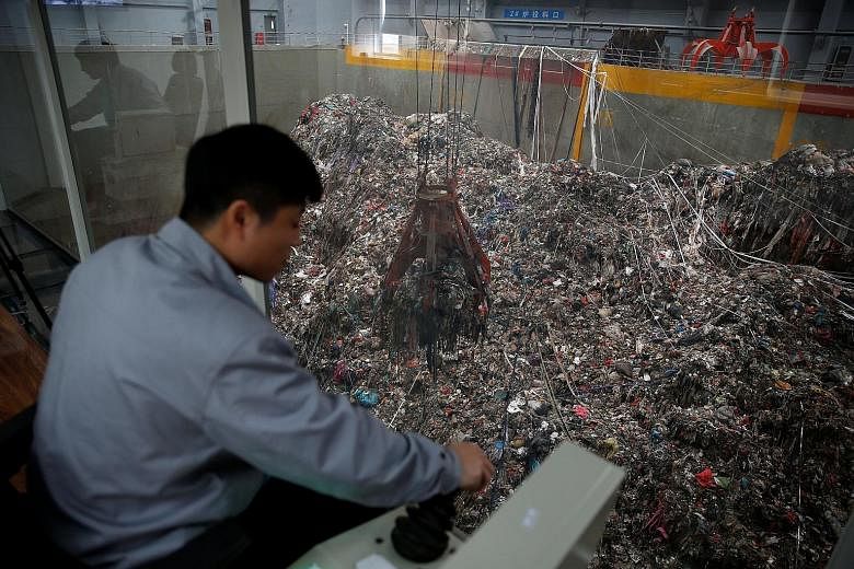 A worker at the new waste-to-energy plant in Wujiang, Jiangsu province, built by China Everbright. The plant is designed to burn 1,500 tonnes of rubbish every day.