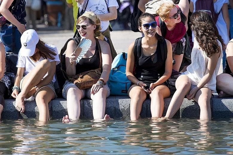Cooling off during a hot September day in Amsterdam. Global temperatures for January to September this year were about 1.2 deg C over pre-industrial levels.