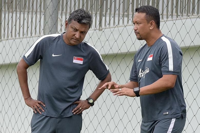 Coach Sundramoorthy and youth head coach Fandi Ahmad during training last month.