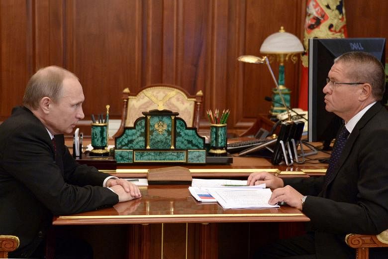 Mr Putin (left) with Mr Ulyukayev in a 2014 photo. The Economy Minister had been tasked with pulling Russia out of the longest economic crisis since Mr Putin took power 16 years ago. 