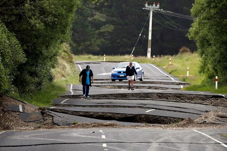Residents near the town of Ward on New Zealand's South Island surveying the damage to State Highway One on Monday.