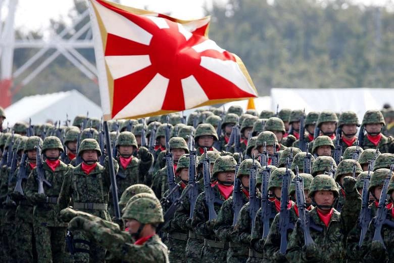 Under new laws, it will be the duty of Japan's Self-Defence Forces (left) to rescue United Nations staff and employees of non-profit groups working in peacekeeping operations in conflict-torn South Sudan if they were to come under siege.