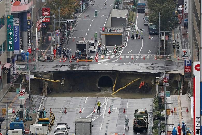 The giant sinkhole (above) which appeared on a five-lane street in the Japanese city of Fukuoka last week has been filled in, and the repaired street reopened to the public yesterday.