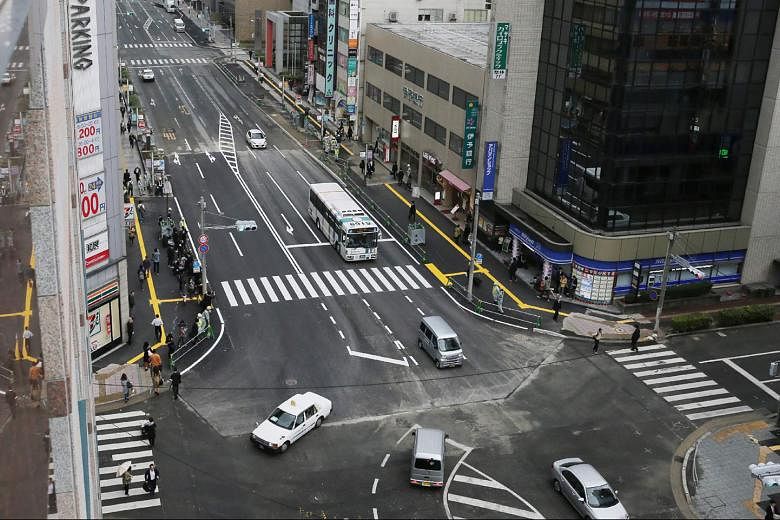 The giant sinkhole which appeared on a five-lane street in the Japanese city of Fukuoka last week has been filled in, and the repaired street (above) reopened to the public yesterday. 