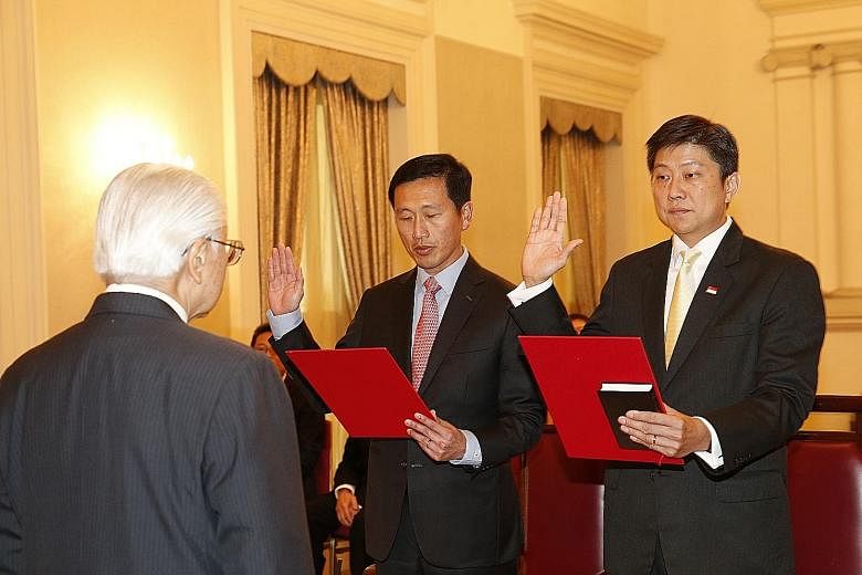 President Tan officiating at the swearing-in and appointment ceremony of Education Ministers Ng Chee Meng (far right) and Ong Ye Kung at the Istana yesterday.
