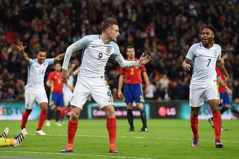 It's party time for Jamie Vardy, Raheem Sterling and Theo Walcott (No. 14), as the Leicester striker celebrates by doing the mannequin challenge after heading past Spanish goalkeeper Jose Reina to put England 2-0 up. But two late goals let the visito