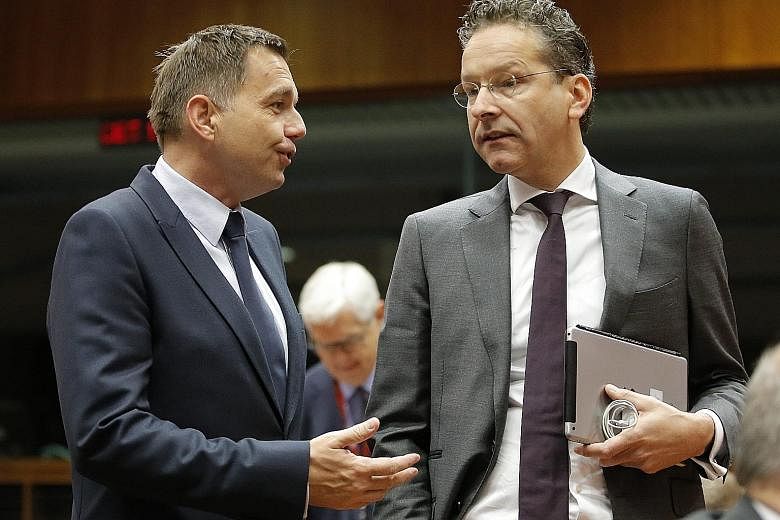 Mr Dijsselbloem (right), with Slovak Finance Minister Peter Kazimir, says Dutch law would not allow for a referendum in the Netherlands on EU membership.