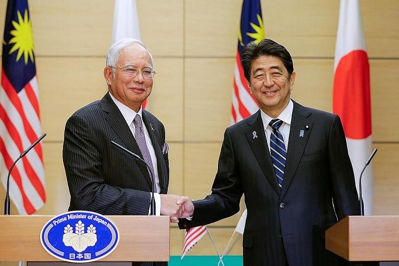 Malaysian Prime Minister Najib Razak (left) with Japanese Prime Minister Shinzo Abe at the end of their joint news conference at Mr Abe's official residence in Tokyo yesterday. Mr Najib says he appreciates the long record of safety and reliability of