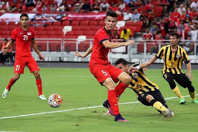 Lions' Baihakki Khaizan (centre) in action during the Causeway Challenge match between Singapore and Malaysia on Oct 7.