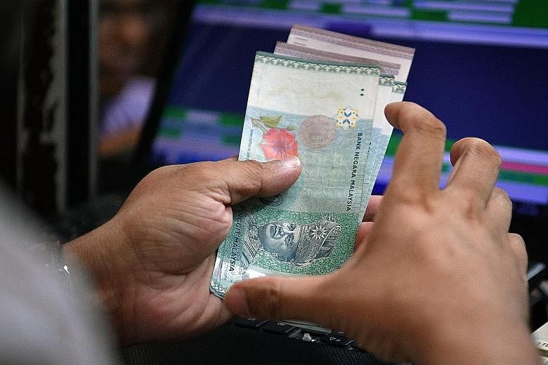 The ringgit fell nearly 1 per cent yesterday to a fresh 11-month low of 4.385 against the US dollar.