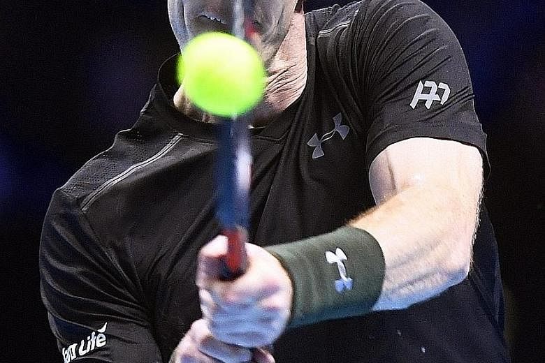 Britain's Andy Murray returns a backhand against Japan's Kei Nishikori at the ATP World Tour Finals in London on Wednesday. The world No. 1 triumphed 6-7 (9-11), 6-4, 6-4 in 3hr 20min and is likely to face Novak Djokovic in the final on Sunday in a m