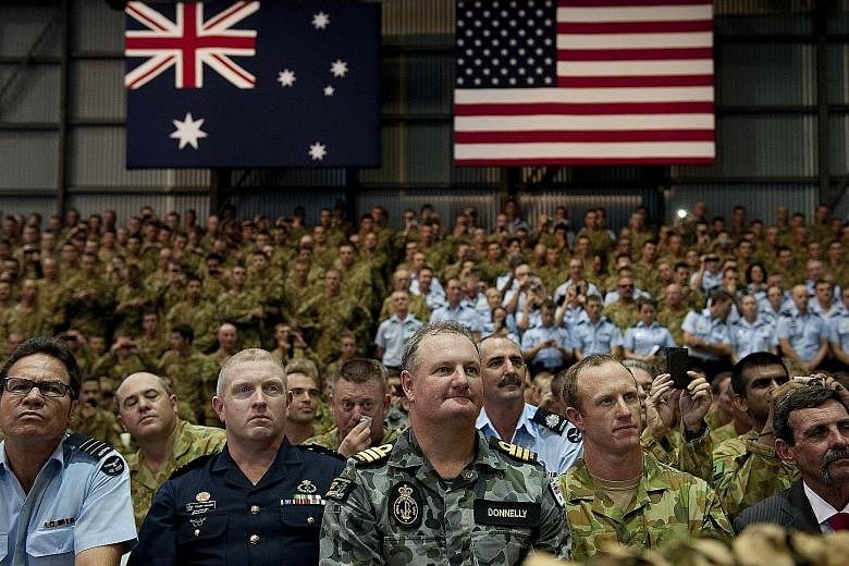 Australian troops and US Marines listening as Mr Obama gave a speech at the Royal Australian Air Force's Base Darwin in 2011. Australian troops have fought alongside the US' in each of its foreign wars.