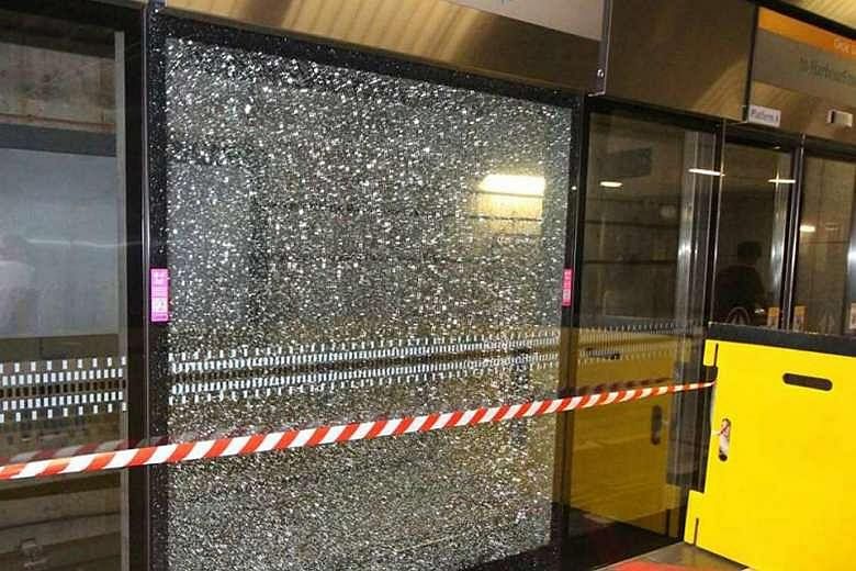 The cracked glass panel at one-north MRT station in a picture taken by a HardwareZone user around 6.30pm on Wednesday. The panel was replaced early yesterday morning during off-service hours.