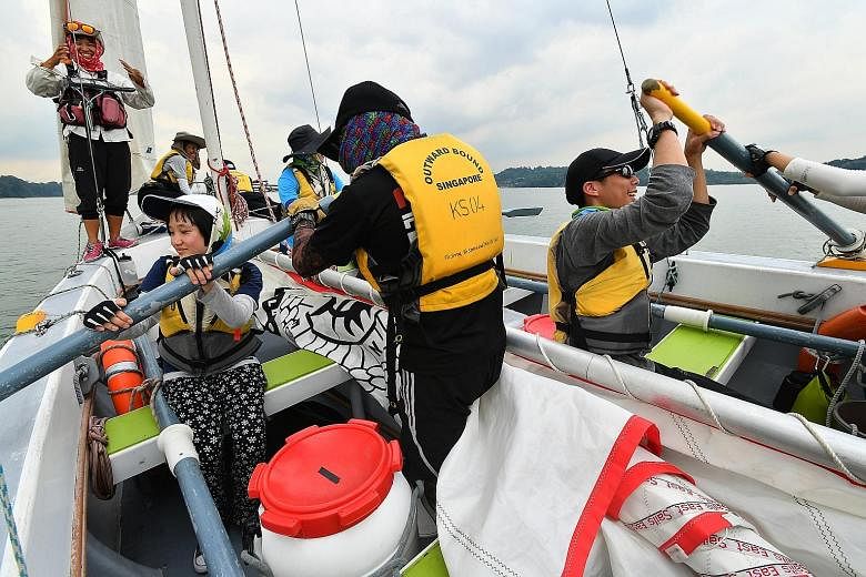 Lee Yan Ling (sitting, left), 14, a student from Rainbow Centre Margaret Drive School, and Loo Yang Rui Erik Lars (sitting, right), 17, a JC 1 student from Serangoon Junior College, rowing in the cutter sailboat on Wednesday as part of Outward Bound 