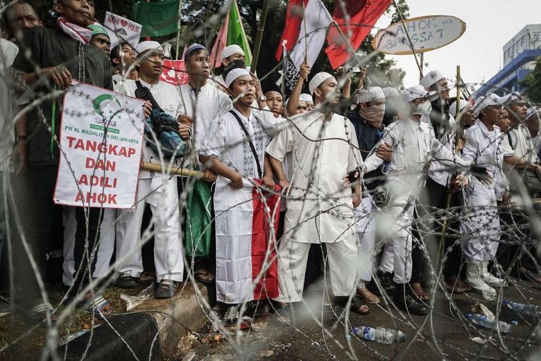 Protesters rallying outside the presidential palace in Jakarta earlier this month against Governor Basuki Tjahaja Purnama over alleged blasphemy. 