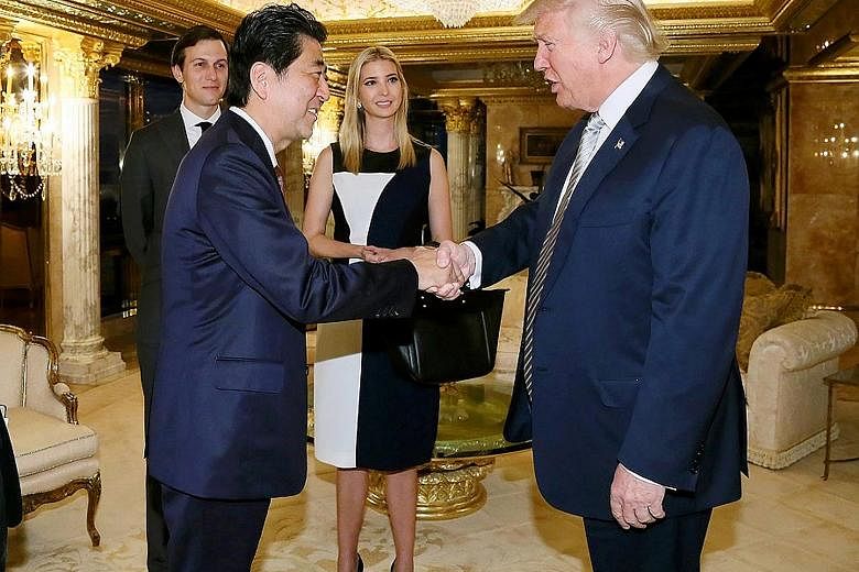Mr Abe being welcomed by Mr Trump in New York on Thursday. With them were Mr Trump's daughter Ivanka and his son-in-law and adviser Jared Kushner. The meeting partially lifted the cloud of uncertainty that had been cast over ties between the two alli