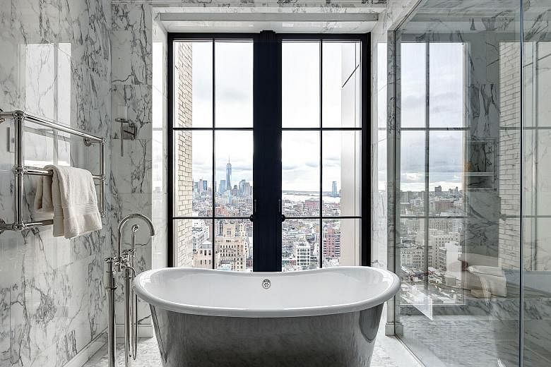 Designed by Uruguayan architect Rafael Vinoly, the 432 Park Avenue residential skyscraper has bathrooms with panoramic views from the tub (left). Large windows and less privacy are among the trends in bathroom design, as seen in this one (above) in W