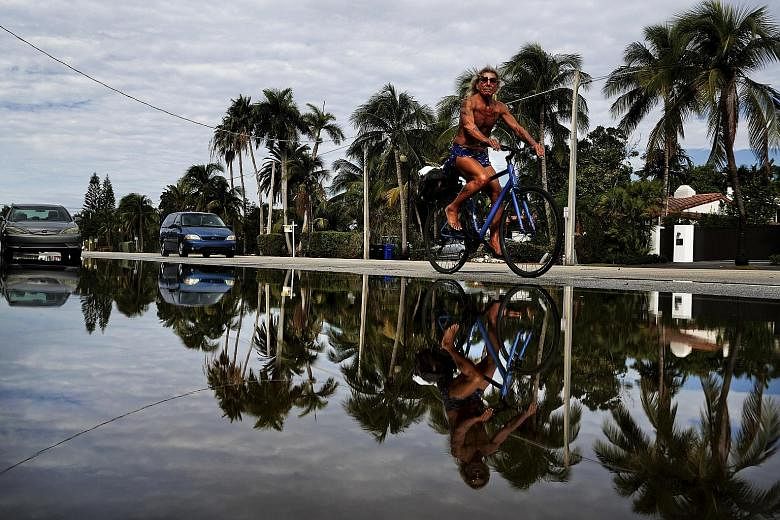A street on Monday flooded with sea water caused by an annual so-called king tide in Fort Lauderdale, a city on Florida's south-eastern coast. King tides, which happen frequently, are the most blatant example of the interplay between rising seas and 