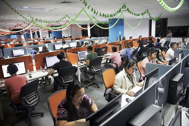Employees at the 24/7 Customer Philippines Inc call centre in Cebu. More than half of call centres in the Philippines are American-owned, accounting for nearly three-fourths of the outsourcing industry's earnings. They employ more than a million work