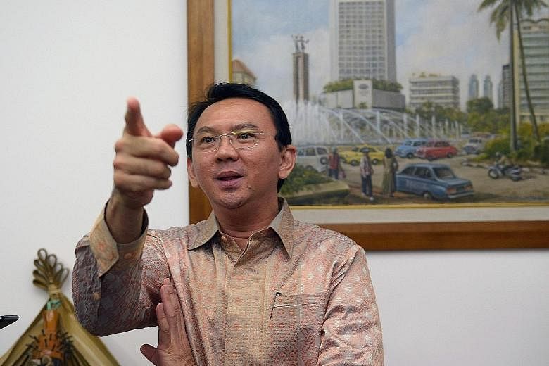Ahok, shown here in a 2014 file photo, says his rivals are capitalising on his being both Chinese and Christian but he still has the support of Muslims among the Jakarta voters.
