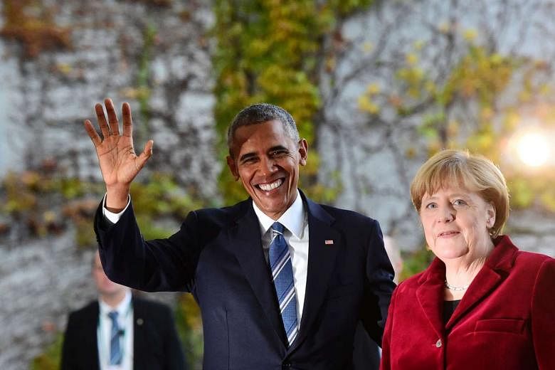 Mr Obama, who was on a farewell visit, being greeted by Dr Merkel in Berlin on Thursday. 