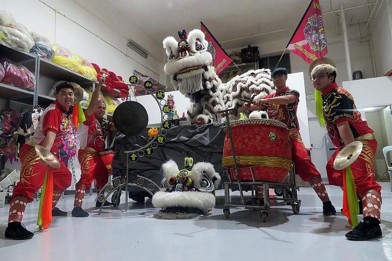 Some lion dance troupe members of the Singapore Teng Ghee Athletic Association. Training for such troupes now incorporates technology, and the groups market themselves through social media. They also help each other out with manpower.