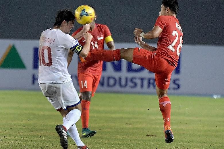 This high studs-up tackle by Hafiz Sujad (right) against Phil Younghusband in the 35th minute earned him a red card in Singapore's 0-0 draw in their AFF Cup opener against the Philippines yesterday.