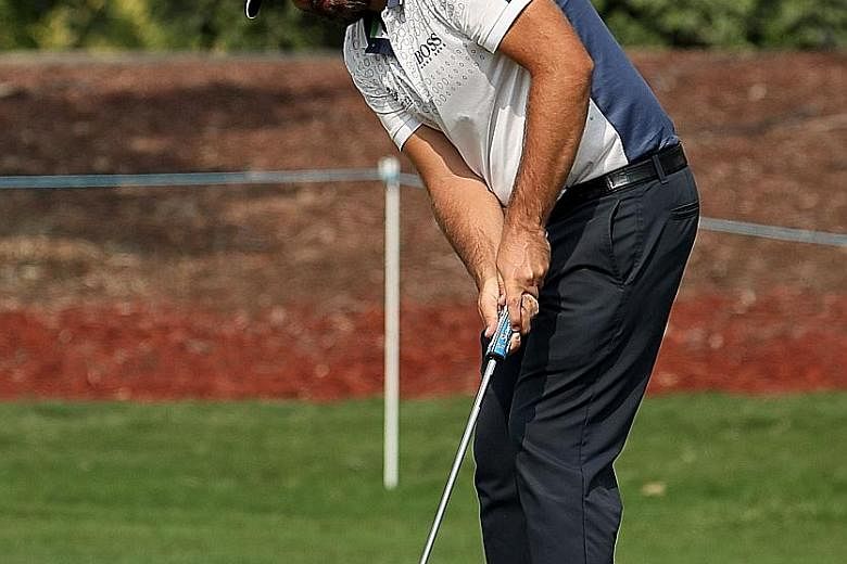 Victor Dubuisson of France putting during the third day of the DP World Tour Championship at the Jumeirah Golf Estates in Dubai. The Frenchman hit an eight-under 64 to move into a one-shot lead.