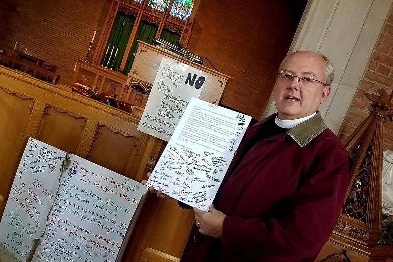 Rev Harvey with messages of support left at his Maryland church after hateful words were found scrawled on the property. A US non-partisan centre that tracks hate crimes and hate groups says that since the Nov 8 presidential election, it has recorded