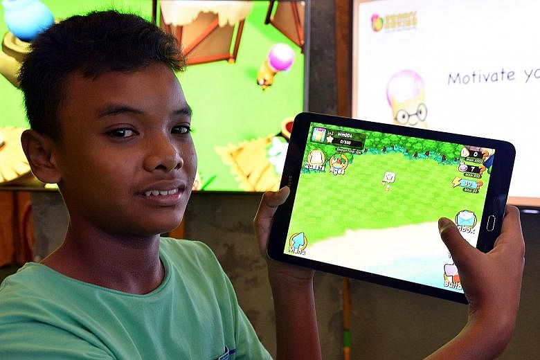 Irfan Shah, 12, playing with Brainy Arkies, a a new mobile learning app by Marshall Cavendish Education aimed at pupils from Primary 1 to 4, consisting of a series of maths quizzes combined with a gaming quest.