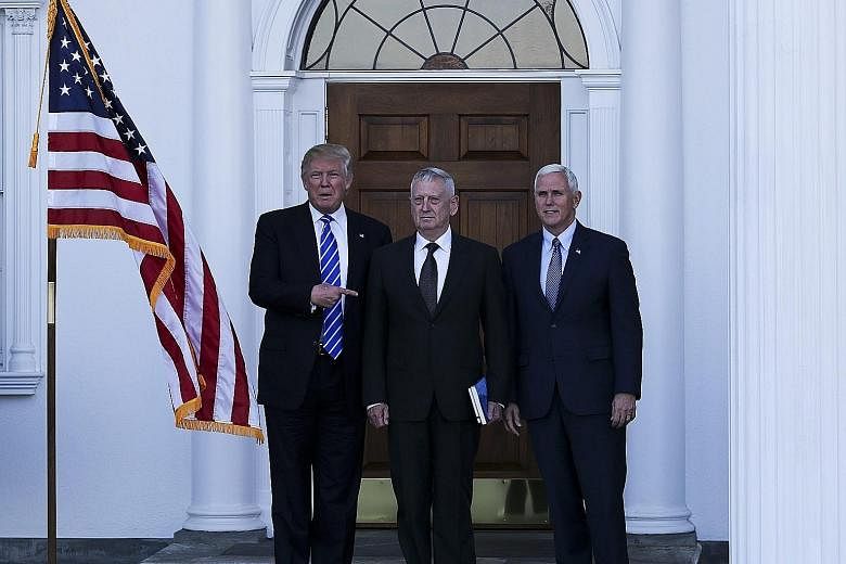 Left: Retired US Marine Corp General James Mattis flanked by Mr Trump (far left) and Mr Pence at the clubhouse of Trump International Golf Club in New Jersey on Saturday. After their meeting, a Trump team statement said Mr Trump and Mr Pence were "ve