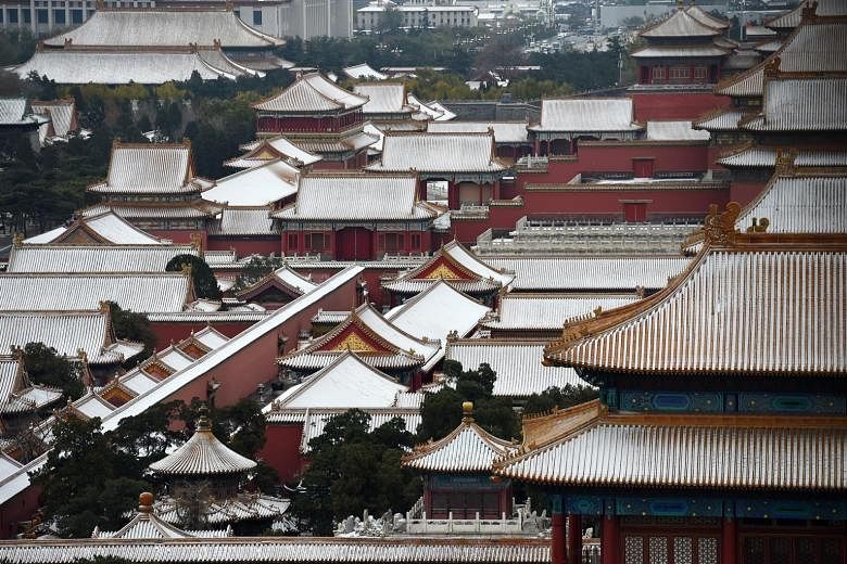 The rooftops of buildings in Beijing's Forbidden City were covered with the first snow of the season yesterday. More than 80 flights leaving from and arriving at the Beijing Capital International Airport were cancelled yesterday owing to the cold wea
