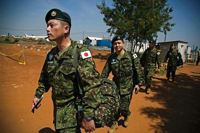 Members of the Japanese Ground Self-Defence Force arriving at the base of the United Nations peacekeeping mission in Juba, South Sudan, yesterday. The deployment of 350 soldiers is in line with Japanese security legislation to expand the military's r